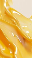 Smooth flowing honey texture with glossy golden waves and light reflections creating dynamic abstract pattern for food industry backgrounds and designs.
