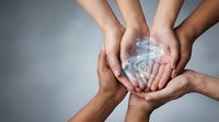 Diverse hands protecting glowing Earth globe symbolizing global unity, environmental protection, teamwork and worldwide cooperation for sustainability.