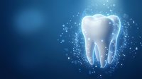 Glowing white tooth with sparkling particles on blue gradient background for dental care and oral health concepts.