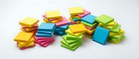 Colorful stacked adhesive notes isolated on white background, ready for office organization, planning, and memo reminders.