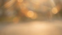 Warm golden bokeh lights with soft blur effect creating dreamy atmospheric background for presentations and design projects.