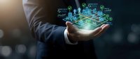 Businessman in suit holding glowing digital smart city hologram with sustainability icons, green energy charts, and urban infrastructure network.