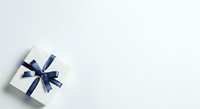 White gift box with navy blue ribbon bow on light background, isolated for holiday, celebration, and promotional design use.