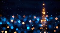 Illuminated communication tower at night with dreamy blue and golden bokeh lights creating magical atmosphere against dark sky. Telecommunications concept.