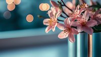 Pink alstroemeria flowers in modern metallic vase against blurred teal background with soft bokeh lights creating romantic atmospheric composition.