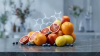 Fresh citrus fruits with vitamin C molecular structure overlay on modern kitchen counter for healthy nutrition and wellness concepts.