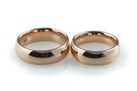 Pair of rose gold wedding bands on white background, classic polished finish rings showing matching his and hers set isolated for jewelry design and marketing.