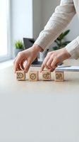 Business professional arranging wooden blocks with productivity icons on office desk for project management and workflow optimization concepts.