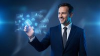 Professional businessman in suit interacting with holographic data visualization and charts on blue background for business technology concepts.