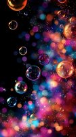 Floating soap bubbles against colorful bokeh background with vibrant pink, blue and orange lights creating magical atmospheric effect for festive designs.