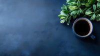 Fresh cup of black coffee and green plant on dark blue background with copy space for text, minimalist flat lay composition for social media and blogs.