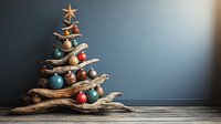 Rustic driftwood Christmas tree decorated with colorful baubles and starfish on wooden surface against blue wall for holiday home decor and seasonal crafts.