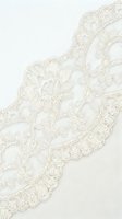 Delicate ivory lace trim with ornate floral embroidery and scalloped edges on white background. Isolated design element suitable for wedding invitations, fashion, and textile projects.