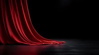 Red velvet curtain draped on dark floor with dramatic lighting, creating elegant theatrical atmosphere for stage, entertainment and performance backgrounds.