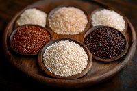 Variety of multicolored quinoa grains in wooden bowls on dark rustic background. Raw organic ancient superfood rich in protein and nutrients.