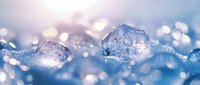 Frozen ice crystals with bokeh light effects in blue winter background, macro photography showing detailed crystalline structure and magical sparkle effects.