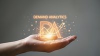 Businesswoman hand holding glowing neon demand analytics symbol with golden light particles on gray background for business intelligence and market research.
