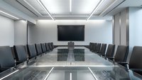 Modern corporate boardroom with glass conference table and black leather chairs for business meetings and executive presentations.