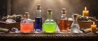 Colorful glass bottles with magical potions and elixirs on wooden table with candles, crystals and herbs creating mystical alchemy laboratory atmosphere.