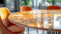 Luxurious round marble dining table with orange epoxy resin pattern and modern orange chairs in sunlit contemporary interior space. Natural light creates glossy reflections.