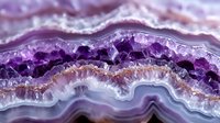 Purple amethyst geode cross-section displaying natural crystal formations and banded agate layers in vibrant violet hues for mineral collection displays.
