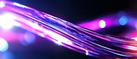 Glowing fiber optic cables with purple and blue light streaks against dark background create dynamic motion effect for technology and communication designs.