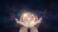 Cupped hands holding glowing brain with bright light rays against dark cosmic background for mental health and neuroscience concepts.