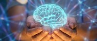 Glowing digital brain hologram floating above cupped hands with neural network connections and light rays for AI technology and neuroscience concepts.