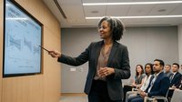 Professional African American businesswoman presenting financial data on digital screen to diverse corporate team in modern conference room.