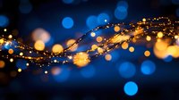 Glowing golden string lights and blue bokeh create magical atmosphere with blurred sparkles and luminous dots against dark background.