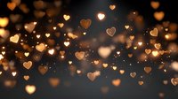 Romantic golden heart bokeh lights floating on dark background creating warm atmospheric glow for Valentine's Day, wedding, anniversary celebrations.