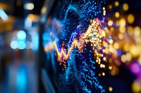 Abstract blurred background with glowing blue and golden bokeh lights creating dynamic wave pattern, defocused magical sparkles for festive atmosphere.