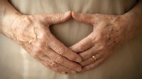 Elderly hands forming heart shape gesture showing love care and compassion in senior healthcare and family bonding concept for emotional wellness support.