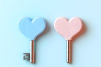 Two heart-shaped keys in pastel blue and pink colors on light blue background, minimal romantic concept for love, relationships and security solutions.
