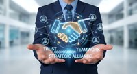 Professional businessman in dark suit presenting holographic handshake with digital network icons representing trust, cooperation, teamwork and strategic alliance concepts.