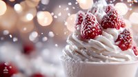 Fresh raspberries topped with powdered sugar on swirled white cream dessert against soft bokeh background creates romantic mood for food photography.
