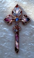 Ornate stained glass cross with pink and purple tones, featuring blue gemstone centerpiece and copper framework on light background. For religious and decorative designs.