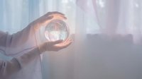 Business professional holding glowing compass in protective hands symbolizing guidance, direction and strategic planning in corporate environment.