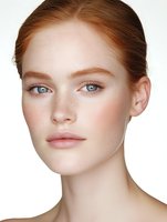 Young redhead woman with freckles and natural makeup portrait on white background. Clean beauty skincare concept for cosmetics advertising.