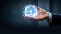Businessman hand holding glowing digital sphere with network connections and light effects on dark background for technology and innovation concepts.