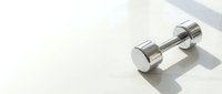 Shiny chrome dumbbell weight on white isolated background, ready for fitness, gym, and health design projects.