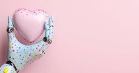 Robotic hand holding pink heart against pastel background with colorful confetti pattern, representing artificial intelligence and emotional connection.