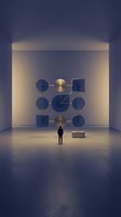 Man standing in modern gallery space viewing geometric wall installation with illuminated circles and squares, representing contemporary art, innovation, and creative contemplation.