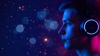 Young Caucasian male gamer with headset in profile against cosmic space background with glowing particles and nebula effects for gaming content.