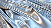Shiny metallic silver fabric with soft folds and wrinkles creating dynamic light reflections and shadows on luxurious material surface. Abstract background pattern.