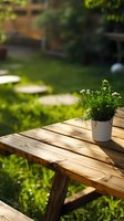 White flowering plant in ceramic pot on wooden garden table, sunlit backyard setting with green lawn and natural bokeh background, peaceful outdoor atmosphere.