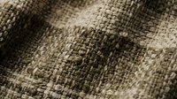Natural burlap fabric texture with woven fibers in brown and beige tones for rustic design projects and organic material backgrounds.