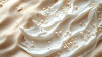 Creamy beige cosmetic product with bubbles and pearls swirled into luxurious texture, showcasing skincare or makeup formulation for beauty and wellness advertising.