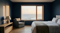 Coastal bedroom with ocean view through large windows, featuring dark navy walls, wooden furniture, comfortable armchair, and modern minimalist decor for relaxation and interior design inspiration.