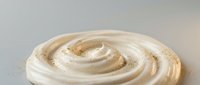 Creamy beige swirl of smooth cosmetic cream or moisturizer with luxurious texture, skincare product for beauty and wellness applications.